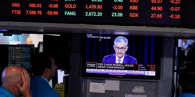 Traders look on as a screen shows Federal Reserve Chairman Jerome Powell's news conference after the U.S. Federal Reserve interest rates announcement on the floor of the New York Stock Exchange.