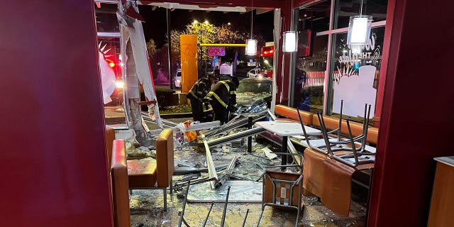 Inside the restaurant, the front of the car smashed through a seating area and seemingly sent tables and chairs flying.