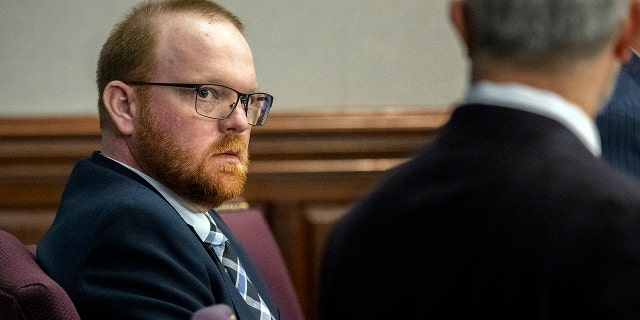 Travis McMichael listens to one of his attorneys during a motion hearing in the Glynn County Courthouse, Thursday, Nov. 4, 2021, in Brunswick, Ga. 