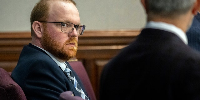 Travis McMichael listens to one of his attorneys during a motion hearing in the Glynn County Courthouse, Thursday, Nov. 4, 2021, in Brunswick, Ga. 