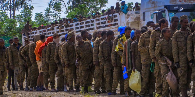 Captured Ethiopian government soldiers and allied militia members line up after being paraded by Tigray forces through the streets in open-top trucks as they arrived to be taken to a detention center in Mekele, the capital of the Tigray region of northern Ethiopia Friday, Oct. 22, 2021. 