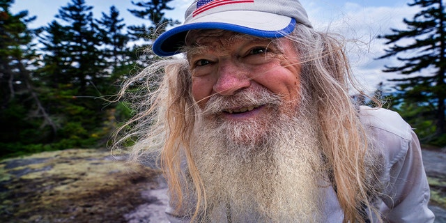 M.J. Eberhart, 83, arrives on the summit of Mount Hayes on the Appalachian Trail, Sunday, Sept. 12, 2021, in Gorham, New Hampshire. Eberhart, who goes by the trail name of Nimblewill Nomad, is the oldest person to hike the entire 2,193-mile Appalachian Trail. (AP Photo/Robert F. Bukaty)