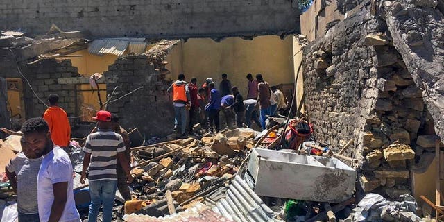 Residents sift through rubble from a destroyed building at the scene of an airstrike in Mekele in the Tigray region of northern Ethiopia Thursday, Oct. 28, 2021.