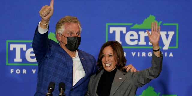 Vice President Kamala Harris waves to the crowd along with Democratic gubernatorial candidate former Gov. Terry McAuliffe during a rally in Norfolk, Va., Friday, Oct. 29, 2021. (AP Photo/Steve Helber)
