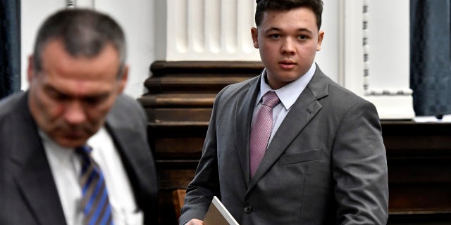 Kyle Rittenhouse walks into court for the start of jury selection on the first day of his trial in Kenosha, Wis., Circuit Court, Monday Nov. 1, 2021. Rittenhouse is accused of killing two people and wounding a third during a protest over police brutality in Kenosha, last year. (Sean Krajacic/The Kenosha News via AP, Pool)