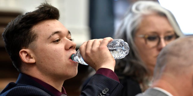 Kyle Rittenhouse drinks water before his defense attorney gives opening statements to the jury at the Kenosha County Courthouse in Kenosha, Wis, on Monday, Nov. 2, 2021.  (Sean Krajacic/The Kenosha News via AP, Pool)