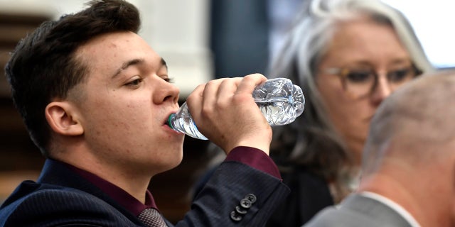 Kyle Rittenhouse drinks water before his defense attorney gives opening statements to the jury at the Kenosha County Courthouse in Kenosha, Wis, on Monday, Nov. 2, 2021. (Sean Krajacic/The Kenosha News via AP, Pool)