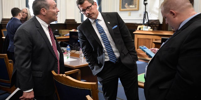 Mark Richards, Kyle Rittenhouse's lead attorney, left, talks with Assistant District Attorney Thomas Binger, center, during a break in Rittenhouse's trial at the Kenosha County Courthouse in Kenosha, Wisconsin, on Wednesday, Nov. 3 2021. Rittenhouse is accused of killing two people and wounding a third during a protest over police brutality in Kenosha last year.