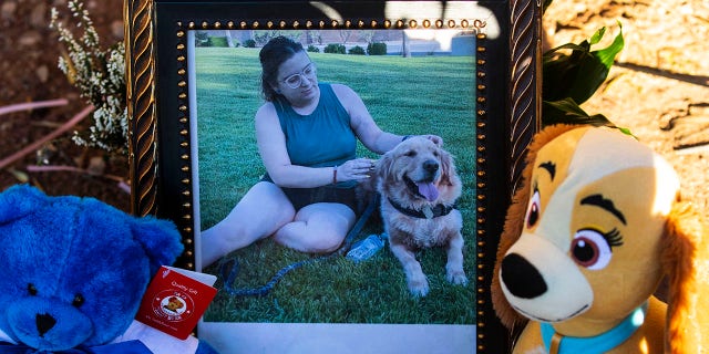 A photography of Tina Tintor, 23, and her dog is placed at a makeshift memorial site to honor them at South Rainbow Boulevard and Spring Valley Parkway, on Thursday, Nov. 4, 2021, in Las Vegas. Tintor and her dog were killed when Raiders wide receiver Henry Ruggs, accused of DUI, slammed into the rear of Tintor's vehicle.