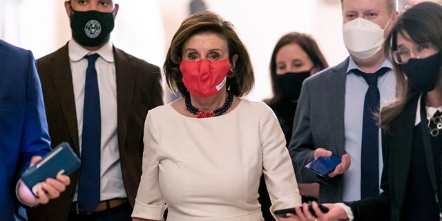 House Speaker Nancy Pelosi walks with reporters at the Capitol on Nov. 4, 2021. (AP Photo/J. Scott Applewhite)