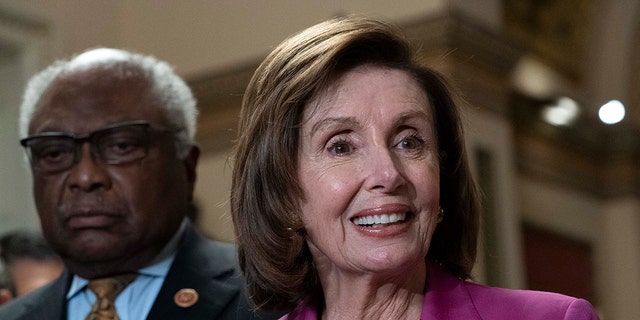 Speaker of the House Nancy Pelosi, D-Calif., accompanied by House Majority Whip James Clyburn, D-S.C., left speaks to reporters at the Capitol in Washington, Friday, Nov. 5, 2021. 