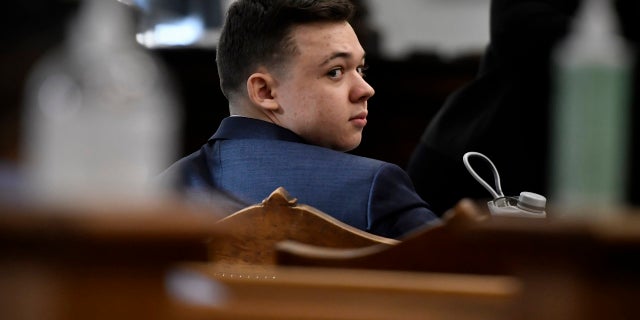 Kyle Rittenhouse looks back before his trial starts at the Kenosha County Courthouse in Kenosha, Wis., on Monday, Nov. 8, 2021. (Sean Krajacic/The Kenosha News via AP, Pool)