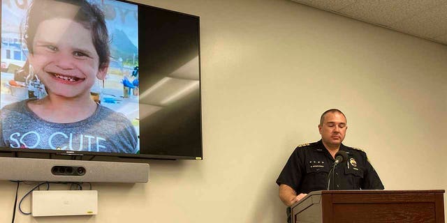 Honolulu Police Maj. Ben Moszkowicz addresses a news conference in Honolulu Wednesday, Nov. 10, 2021, where officers said they had arrested the adoptive parents of Isabella "Ariel" Kalua, shown on the screen to the left. The parents, Lehua and Isaac "Sonny" Kalua, have been charged with second-degree murder in the girl's death. Police say the girl was killed a month before they reported her missing Sept. 13, 2021. 