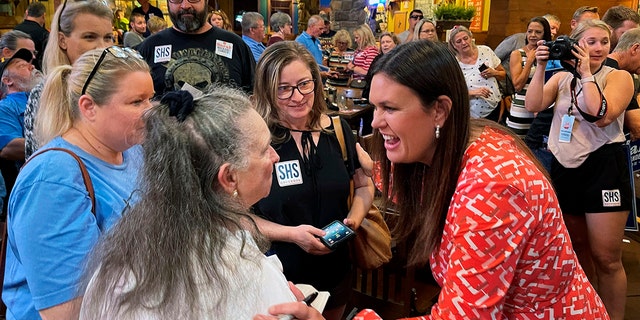 Former White House press secretary Sarah Sanders, right, greets supporters at an event for her campaign for governor at a Colton's Steak House on Sept. 10, 2021, in Cabot, Arkansas.
