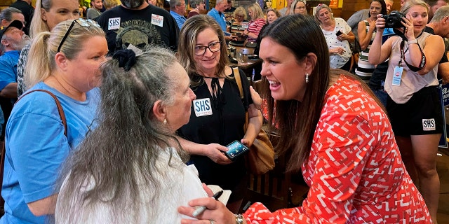 Former White House press secretary Sarah Sanders, right, greets supporters on the campaign trail, at an event at Colton's Steak House on Sept. 10, 2021, in Cabot, Arkansas. Sanders is her state's 2022 GOP gubernatorial nominee.