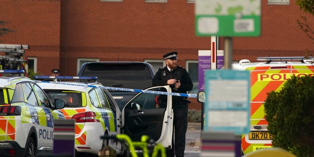 Emergency services outside Liverpool Women's Hospital in Liverpool, England, Sunday, Nov. 14, 2021. Counter-terrorism police in Britain are investigating an explosion at a hospital Sunday in the city of Liverpool that killed one person and injured another. Police were called to reports of a blast involving a taxi that pulled up at Liverpool Women’s Hospital shortly before the explosion took place Sunday morning. (Peter Byrne/PA via AP)