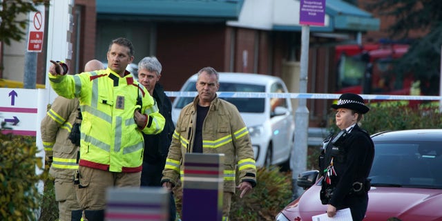 Emergency services outside Liverpool Women's Hospital in Liverpool, England, Sunday, Nov. 14, 2021. Counter-terrorism police in Britain are investigating an explosion at a hospital Sunday in the city of Liverpool that killed one person and injured another. Police were called to reports of a blast involving a taxi that pulled up at Liverpool Women’s Hospital shortly before the explosion took place Sunday morning. (Peter Byrne/PA via AP)