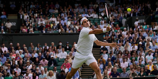 Switzerland's Roger Federer plays a return to Poland's Hubert Hurkacz during the men's singles quarterfinals match on day nine of the Wimbledon Tennis Championships in London, Wednesday, July 7, 2021.