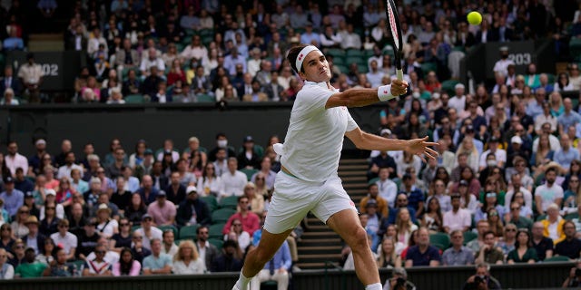 Switzerland's Roger Federer plays a return to Poland's Hubert Hurkacz during the men's singles quarterfinals match on day nine of the Wimbledon Tennis Championships in London, Wednesday, July 7, 2021.