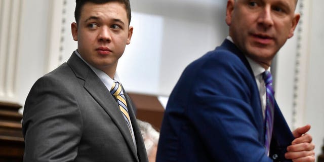 Kyle Rittenhouse, left, and his attorney, Corey Chirafisi, stand after meeting with Judge Bruce Schroeder for questions on video the jury has asked for while it deliberates at the Kenosha County Courthouse in Kenosha, Wis., on Wednesday, Nov. 17, 2021. (Sean Krajacic/The Kenosha News via AP, Pool)