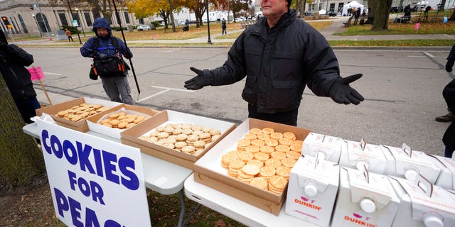 Kenosha County Sheriff David Beth offers cookies and coffee outside the Kenosha County Courthouse, Thursday, Nov. 18, 2021 in Kenosha, Wis., during the Kyle Rittenhouse murder trial. Rittenhouse is accused of killing two people and wounding a third during a protest over police brutality in Kenosha, last year. (AP Photo/Paul Sancya)