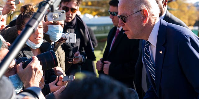 Biden leans to hear a reporter's question as he returns to the White House, Friday, Nov. 19, 2021, in Washington, from Walter Reed National Military Medical Center.