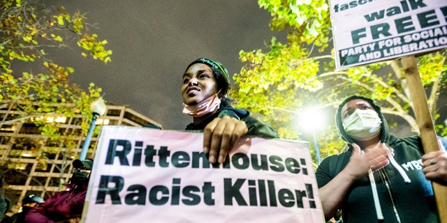 Bria Swenson holds a sign Friday, Nov. 19, 2021, in Oakland, Calif., following the acquittal of Kyle Rittenhouse in Kenosha, Wis. (AP Photo/Noah Berger)