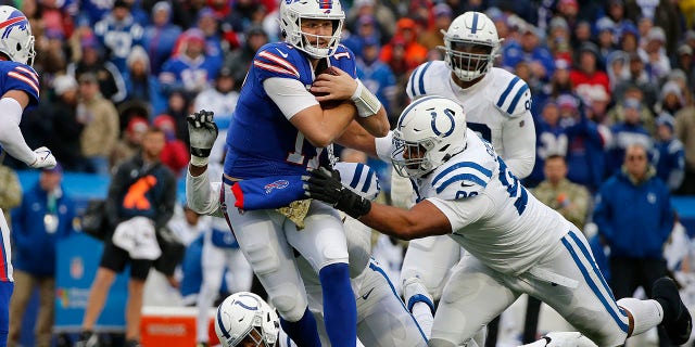 Buffalo Bills quarterback Josh Allen (17) is tackled by Indianapolis Colts defensive tackle Antwaun Woods (96) during the first half in Orchard Park, N.Y., Sunday, Nov. 21, 2021.