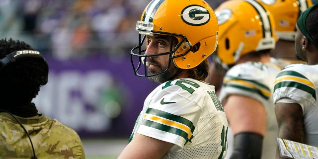 Green Bay Packers quarterback Aaron Rodgers (12) stands on the sideline during the second half of an NFL football game against the Minnesota Vikings, Sunday, Nov. 21, 2021, in Minneapolis.