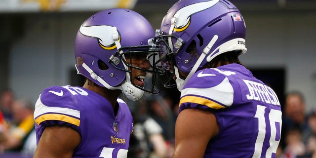 Minnesota Vikings wide receiver Justin Jefferson (18) celebrates with teammate Dede Westbrook (12) after catching a 23-yard touchdown pass during the second half against the Green Bay Packers, Sunday, Nov. 21, 2021, in Minneapolis.