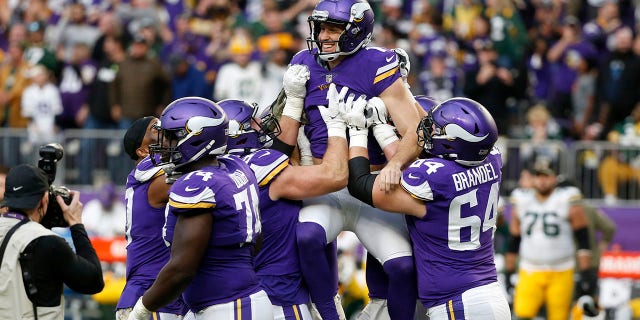Minnesota Vikings kicker Greg Joseph, center, celebrates with teammates after kicking a 29-yard field goal on the final play of an NFL football game against the Green Bay Packers, Sunday, Nov. 21, 2021, in Minneapolis. The Vikings won 34-31.