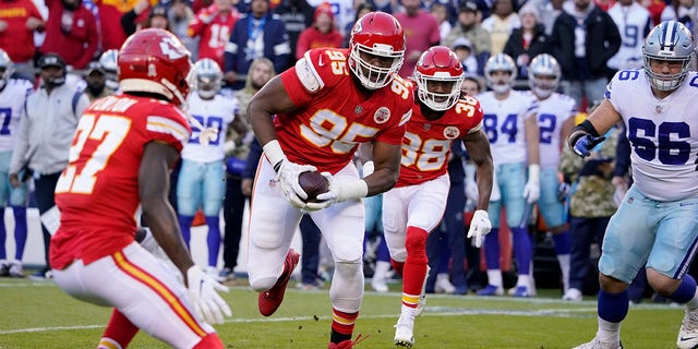 Kansas City Chiefs defensive tackle Chris Jones runs with the ball after recovering a fumble during the first half against the Dallas Cowboys Sunday, Nov. 21, 2021, in Kansas City, Mo.