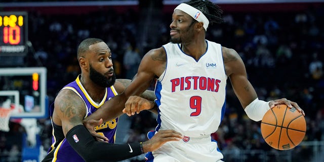 Detroit Pistons forward Jerami Grant (9) is defended by Los Angeles Lakers forward LeBron James (6) during the first half Sunday, Nov. 21, 2021, in Detroit.