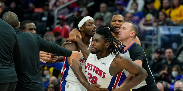 Detroit Pistons center Isaiah Stewart (28) is held back after a foul during the second half of an NBA basketball game against the Los Angeles Lakers, Sunday, Nov. 21, 2021, in Detroit.