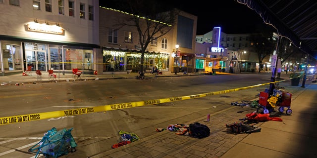 Police tape cordons off a street in Waukesha, Wys., after an SUV plowed into a Christmas parade hitting multiple people Sunday, Nov.. 21, 2021. 