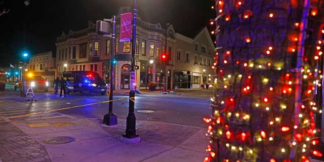 Police canvass the streets in downtown Waukesha, Wis., after a vehicle plowed into a Christmas parade hitting multiple people Sunday, Nov. 21, 2021. (AP Photo/Jeffrey Phelps)