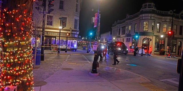 Police canvass the streets in downtown Waukesha, Wis., after a vehicle plowed into a Christmas parade hitting more than 20 people Sunday, Nov. 21, 2021. 
