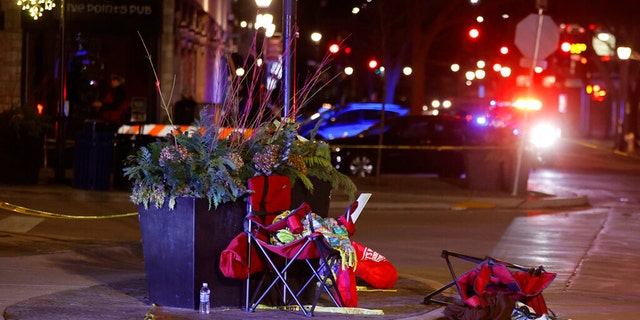 Toppled chairs are seen among holiday decorations in downtown Waukesha, Wis., after an SUV plowed into a Christmas parade injuring dozens of people Sunday, Nov 21. 2021. (AP Photo/Jeffrey Phelps)