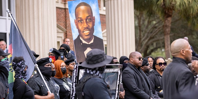 Black Lives Matter and Black Panther protesters gather outside the Glynn County Courthouse, where the trial of three men in slaying of Ahmaud Arbery is being held, on Monday, Nov. 22, 2021, in Brunswick, Georgia. (AP Photo/Stephen B. Morton)
