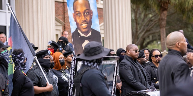 Black Lives Matter and Black Panther protesters gather outside the Glynn County Courthouse, where the trial of three men in slaying of Ahmaud Arbery is being held, on Monday, Nov. 22, 2021, in Brunswick, Georgia. (AP Photo/Stephen B. Morton)