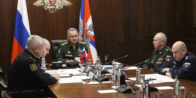 Russian Defense Minister Sergei Shoigu, center, takes part in a  call with his Chinese counterpart Wei Fenghe in Moscow, Russia, Tuesday, Nov. 23, 2021. 