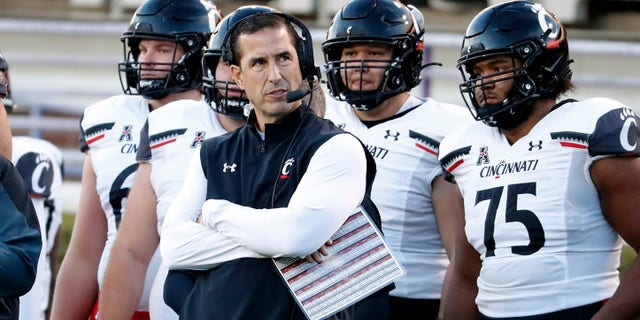 Cincinnati head coach Luke Fickell watches from the sidelines during the first half of an NCAA college football game against East Carolina in Greenville, N.C., Friday, Nov. 26, 2021. 