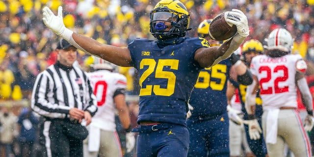 Michigan running back Hassan Haskins (25) celebrates a touchdown in the fourth quarter of an NCAA college football game against Ohio State in Ann Arbor, Mich., Saturday, Nov. 27, 2021. Michigan won 42-27.