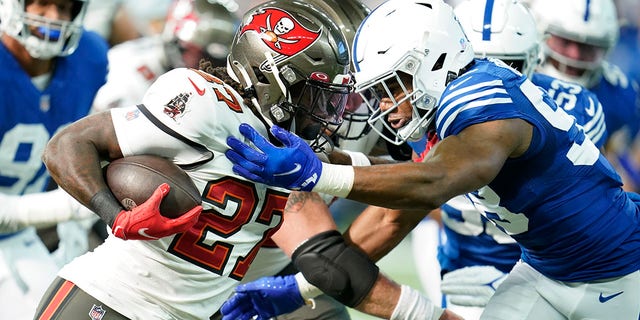 Ronald Jones (27) of the Tampa Bay Buccaneers faces Bobby Okereke (58) of the Indianapolis Colts in the first half of an NFL football game on Sunday, November 28, 2021, in Indianapolis.