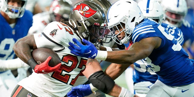 Ronald Jones (27) of the Tampa Bay Buccaneers faces Bobby Okereke (58) of the Indianapolis Colts in the first half of an NFL football game on Sunday, November 28, 2021, in Indianapolis.