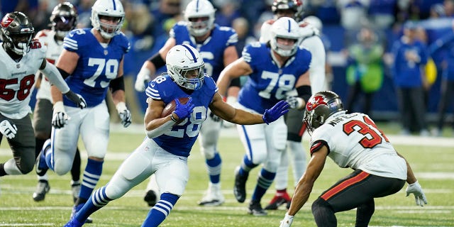 Tampa Bay Buccaneer Antoine Winfield Jr. (31) prepares to tackle the Indianapolis Colts' Jonathan Taylor (28) during the first half Sunday, Nov. 28, 2021, in Indianapolis.