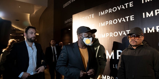 American musician will.i.am, center, arrives for a photo op with his Black Eyed Peas bandmates at the Improvate International Innovation Forum in Jerusalem, Monday, Nov. 29, 2021.