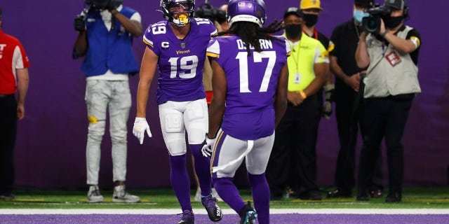 Minnesota Vikings wide receiver Adam Thielen (19) celebrates with teammate K.J. Osborn (17) after catching a 20-yard touchdown pass during the first half of an NFL football game against the Dallas Cowboys, Sunday, Oct. 31, 2021, in Minneapolis.