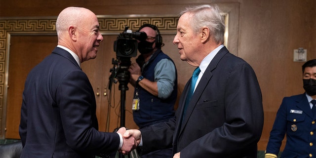 Secretary of Homeland Security Alejandro Mayorkas, left, is greeted by Senate Judiciary Committee Chair Sen. Dick Durbin, D-Ill., during a hearing by the committee, Tuesday, Nov. 16, 2021, on Capitol Hill in Washington.