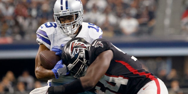 Dallas Cowboys wide receiver Amari Cooper (19) catches a pass as Atlanta Falcons linebacker Foyesade Oluokun (54) makes the stop in the second half of an NFL football game in Arlington, Texas, Sunday, Nov. 14, 2021.